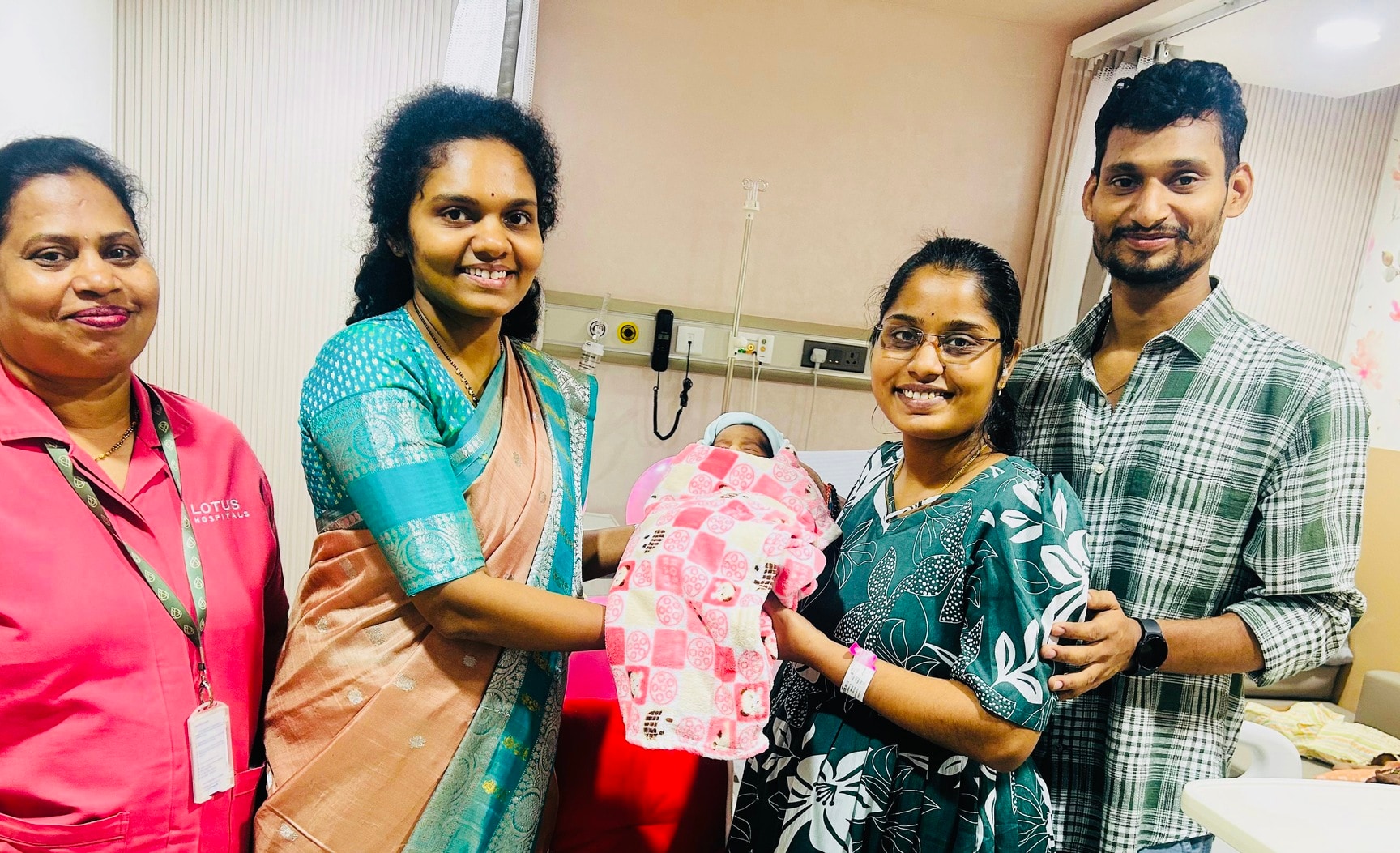 New parents with their baby at Lotus Hospitals